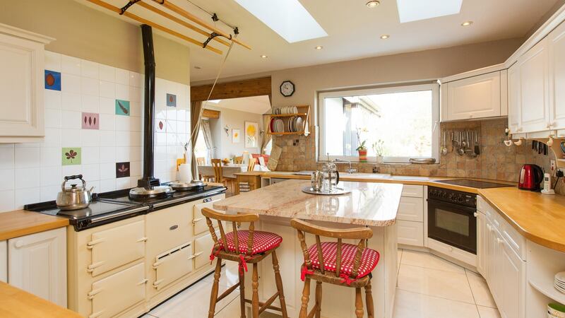 The owners also updated the kitchen, adding an Aga to the welcoming country-style space