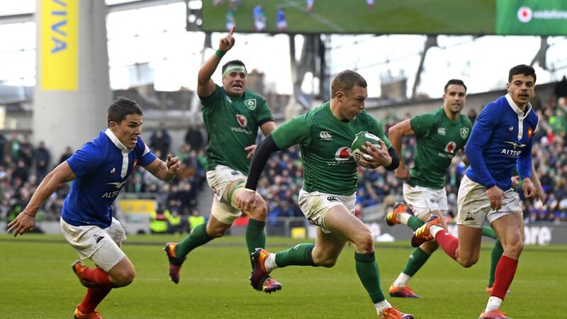 Keith Earls (C) runs in Ireland’s fourth try after France’s Demba Bamba lost sight of his role. Photograph:  Damien Mayer/AFP/Getty Images