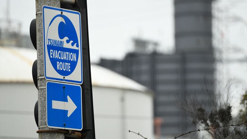 A tsunami evacuation route sign is displayed in El Segundo, California, on Saturday. Photograph: Patrick T  Fallon/AFP via Getty
