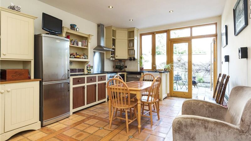 Patio doors open on to the paved rear garden area