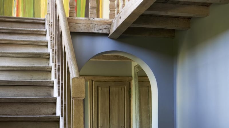 The entrance hall of Alex Flamant’s home. In some rooms in the house,  the beams are painted in one of his new paint colours, After Rain, a soft, sludgy shade inspired by nature.