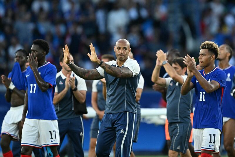 France's coach Thierry Henry and players acknowledge the fans at the end of the men's gold medal final football match between France and Spain. Photograph: Jonathan Nackstrand/AFP via Getty
