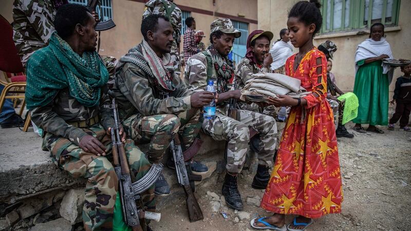A girls hands out food to Tigray Defence Forces fighters in Mekelle on  June 29th. Photograph: Finbarr O’Reilly/New York Times