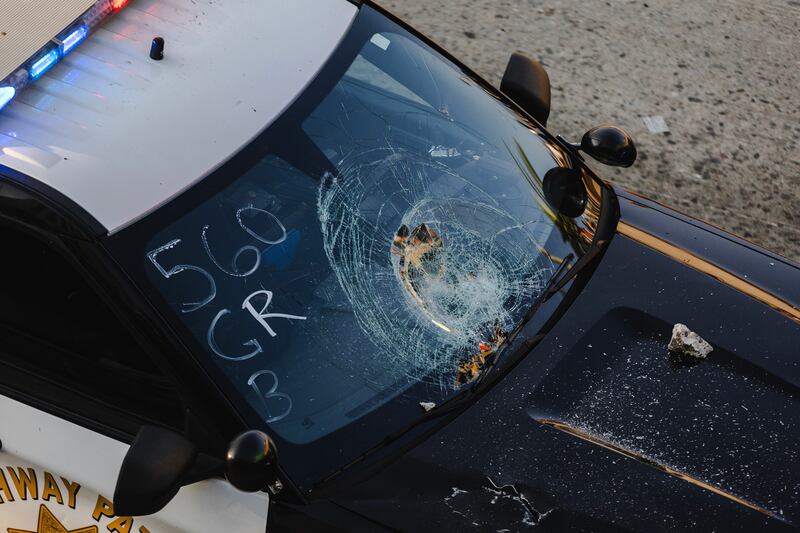 A damaged police vehicle sits on the 101 freeway in downtown Los Angeles. Photograph: Jim Vondruska/Getty Images