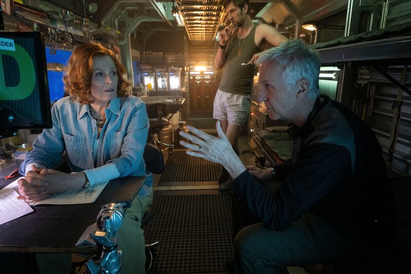 Sigourney Weaver as Dr Grace Augustine, director James Cameron, and Joel David Moore as Norm Spellman on the set of Avatar: Way of Water. Photograph: Mark Fellman.
