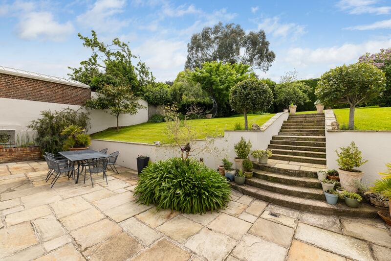 Patio with steps up to back garden