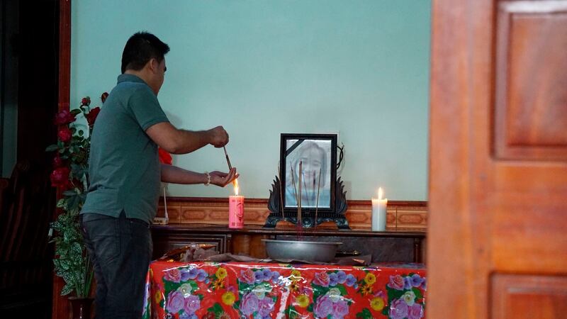 Bui Thi Nhung (19) was also confirmed to be among the dead. Here a family member  lights incense sticks from a candle at an altar with Nhung’s portrait inside her home home in Do Thanh village, Nghe An province, Vietnam.  Photograph: AP Photo/Linh Do