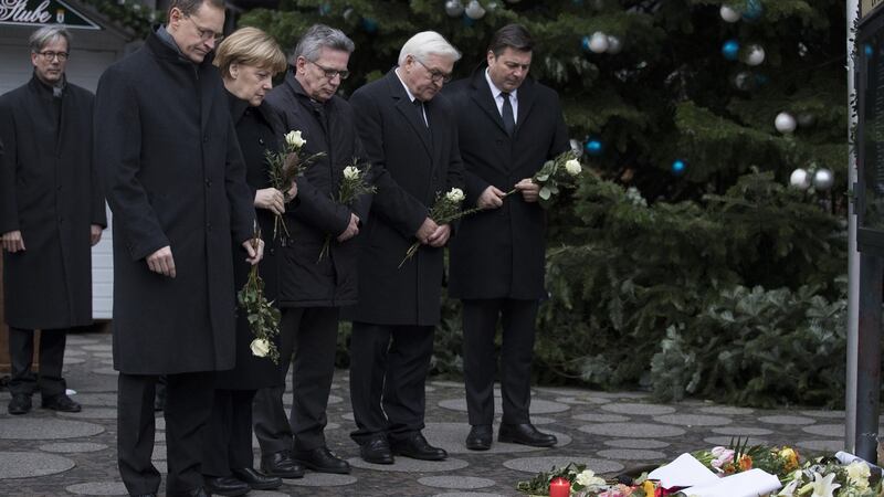 Angela Merkel  with Berlin’s mayor,  Germany’s interior minister, Germany’s foreign minister, Berlin’s interior minister, near the scene of the attack. Photographer: Jasper Juinen/Bloomberg