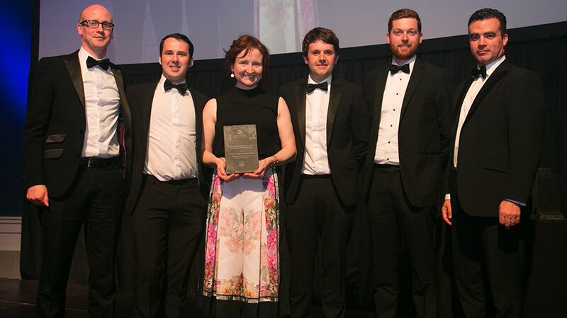 Jim Loughran, commercial director, Kingspan Insulation presents the Sustainability Award for a Single Building or Development Award to Helena McElmeel Architects team.