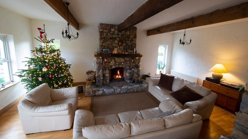 Stone fireplace and timber beams: The living room in  Curracloe, Co Wexford. Photograph: Patrick Browne