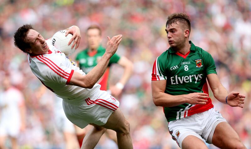 Aidan O’Shea (right) tackles Colm Cavanagh of Tyrone, which resulted in a yellow card for the Mayo player.   Photograph: James Crombie/Inpho