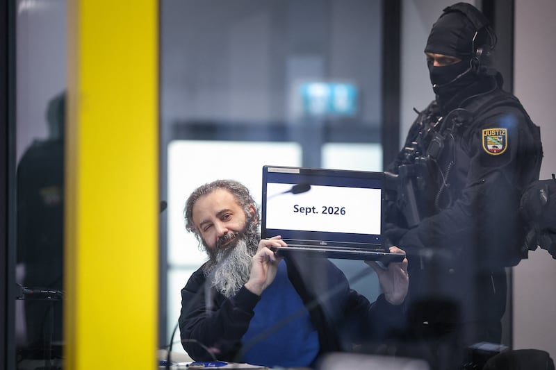 Taleb al-Abdulmohsen holds up a laptop with the lettering "Sept 2026" in a courtroom in Magdeburg, eastern Germany, on Monday. Photograph:  Ronny Hartmann/AFP/Getty Images         