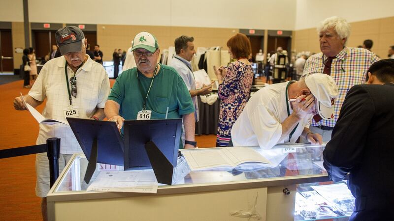 Guests look at items belonging to notorious Boston mobster James ‘Whitey’ Bulger are displayed during before an  auction in Boston, Massachusetts on Friday. Photograph: Scott Eisen/Bloomberg
