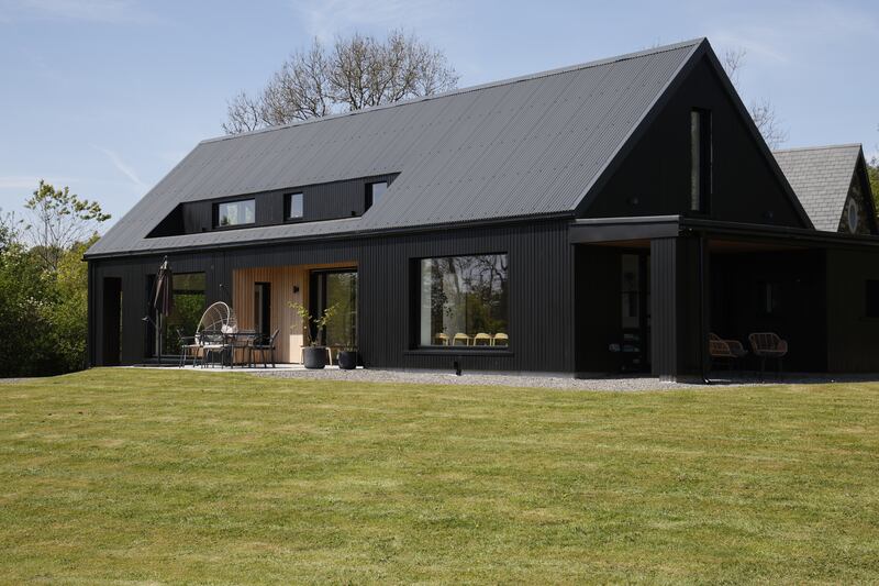 A side view showing the inverted dormer window, corrugated steel roof and the 350 square metres of exterior Siberian larch cladding, made and installed by Conor.