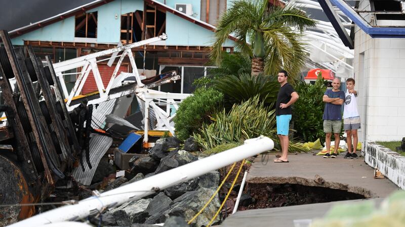 Locals inspect damage to the marina at Shute Harbour near Airlie Beach. Photograph: Dan Peled/EPA