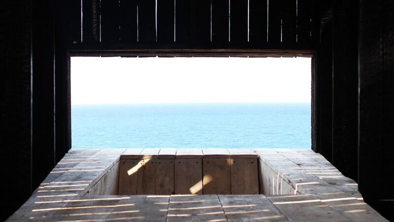 The chapel contains a sunken seat from which to contemplate the sea, and a low door that slows your speed as you enter