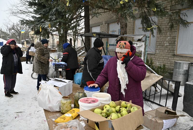 Local residents receive food aid in the village of Posad-Pokrovske, Kherson region. Photograph: Genya Savilov/AFP via Getty Images