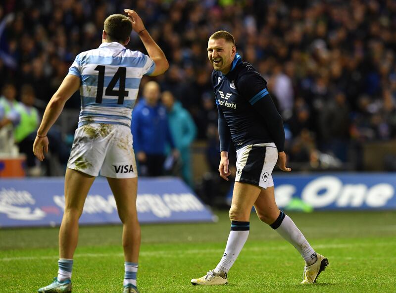 Finn Russell of Scotland tangles with Bautsta Delguy and Juan Cruz Mallia of Argentina. Photograph: Mark Runnacles/Getty