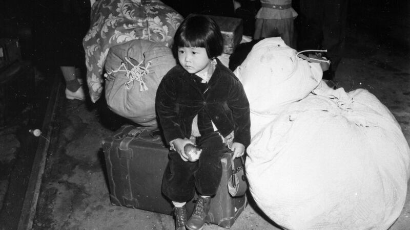 A young evacuee  waits with the family baggage before leaving by bus for an assembly centre in California in  1942. Photograph: Clem Albers/Department of the Interior/War Relocation Authority/National Archives/Reuters