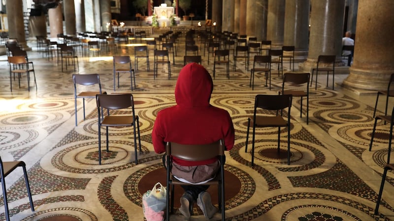 A lone worshipper prays in the Church of Santa Maria in Trastevere, Rome. Photograph: Marco Di Lauro/Getty