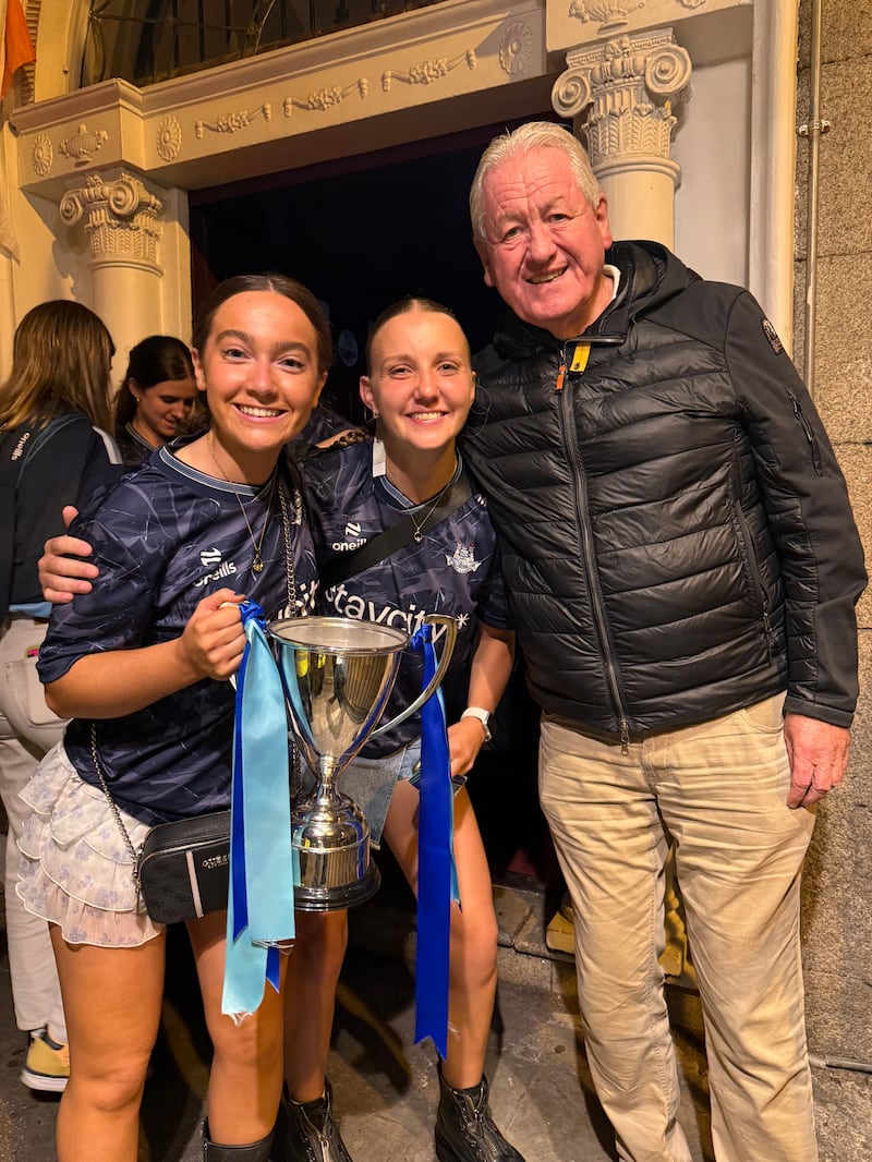 Cathal Jackson, owner of Copper Face Jacks, with captain Aoife Deegan and Meadhbh Hicks of the Dublin under-23 camogie team. Photograph: Conor Pope