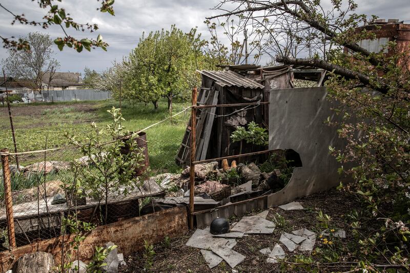 The bodies of Ukrainian soldiers lie in a yard in Vilkhivka, near the eastern city of Kharkiv, Ukraine, after the village was reclaimed from Russian forces.