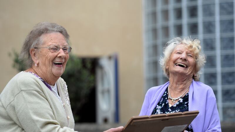 Imelda Dodrill (90) and Margaret Murphy (79) enjoy the celebrations at  Wolfe Tone Close, Dublin 1. Photograph: Dara Mac Dónaill