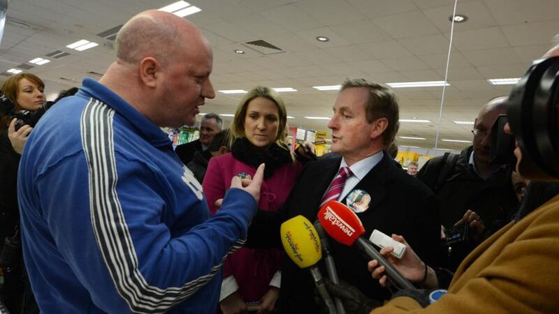 Taoiseach Enda Kenny and candidate Helen McEntee meet an off-duty garda  in Ratoath village. Photograph: Cyril Byrne