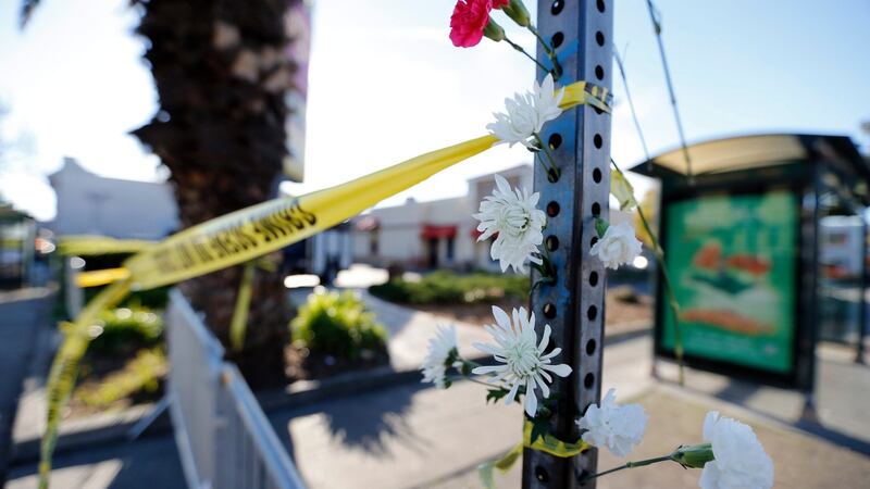 Flowers hanging from a sign post near  the scene of a warehouse fire  in the Fruitvale district of Oakland, California. Photograph: John G Mabanglo/EPA.