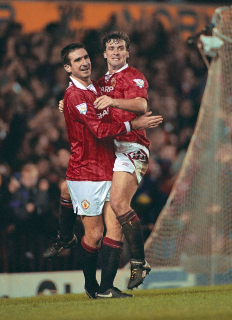 Eric Cantona celebrates scoring with team mate Mark Hughes during a Premier League match between Manchester United and Aston Villa at Old Trafford during the 1993/94 season. Photograph: Clive Brunskill/Allsport/Getty Images/Hulton Archive