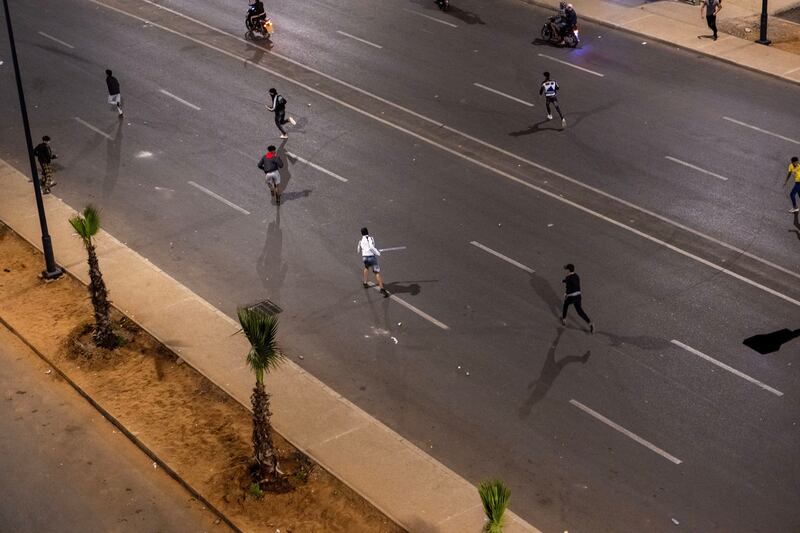 Protesters run during a gathering of youth-led protests demanding healthcare and education reforms in Sale, Morocco. Photograph: EPA