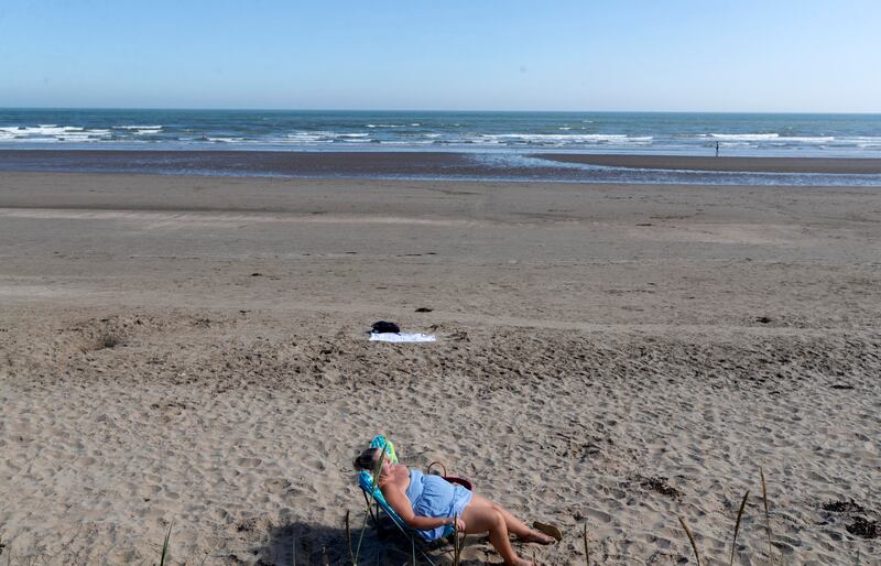 A member of the public relaxes in the sun on Portmarnock Beach. Photograph: Colin Keegan/Collins Dublin