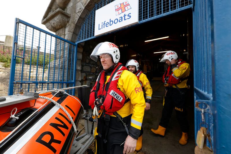 Alan Keville and colleagues Paul Cummins and Don Phillips transport their vessel to the water at Dún Laoghaire. Photograph: Nick Bradshaw/The Irish Times