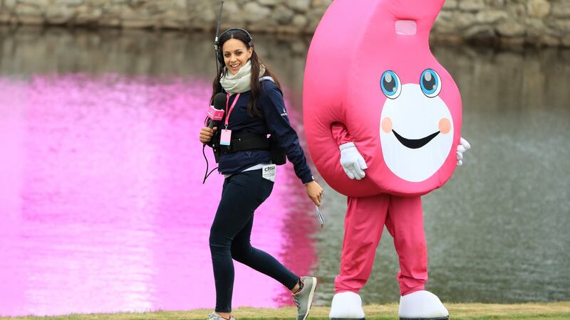 Sky Sports commentator Henni Zuel walks past the Golf Sixes mascot. Photo: Andrew Redington/Getty Images