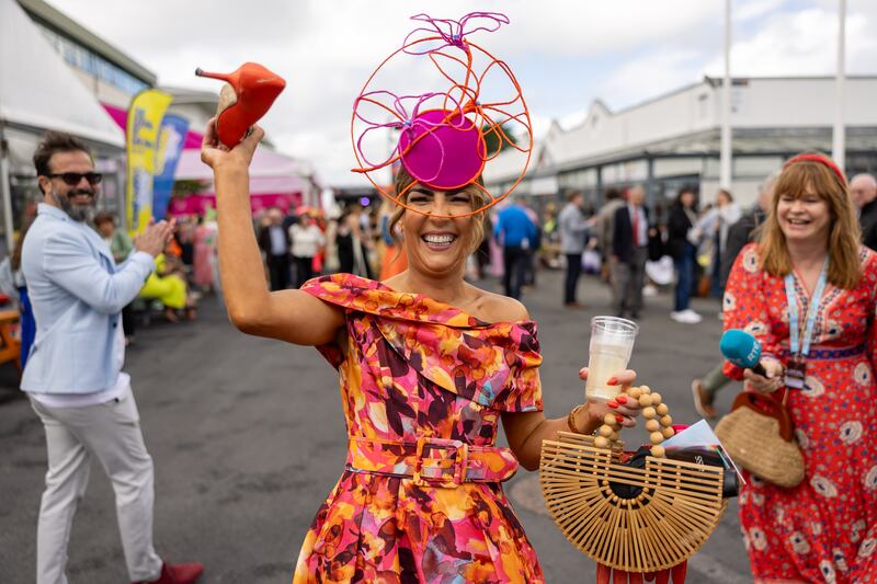 Louisa Murphy from Tramore, Co Waterford, holding her Manolo Blahnik which got caught in a grate at the races. She needed help setting it free. Photograph: Morgan Treacy/Inpho