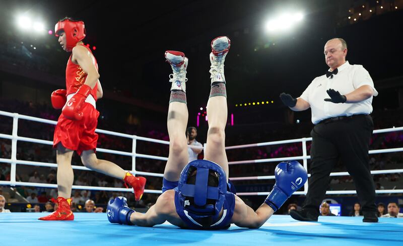Kellie Harrington takes a tumble after a tangle with Wenlu Yang. Photograph: Richard Pelham/Getty Images