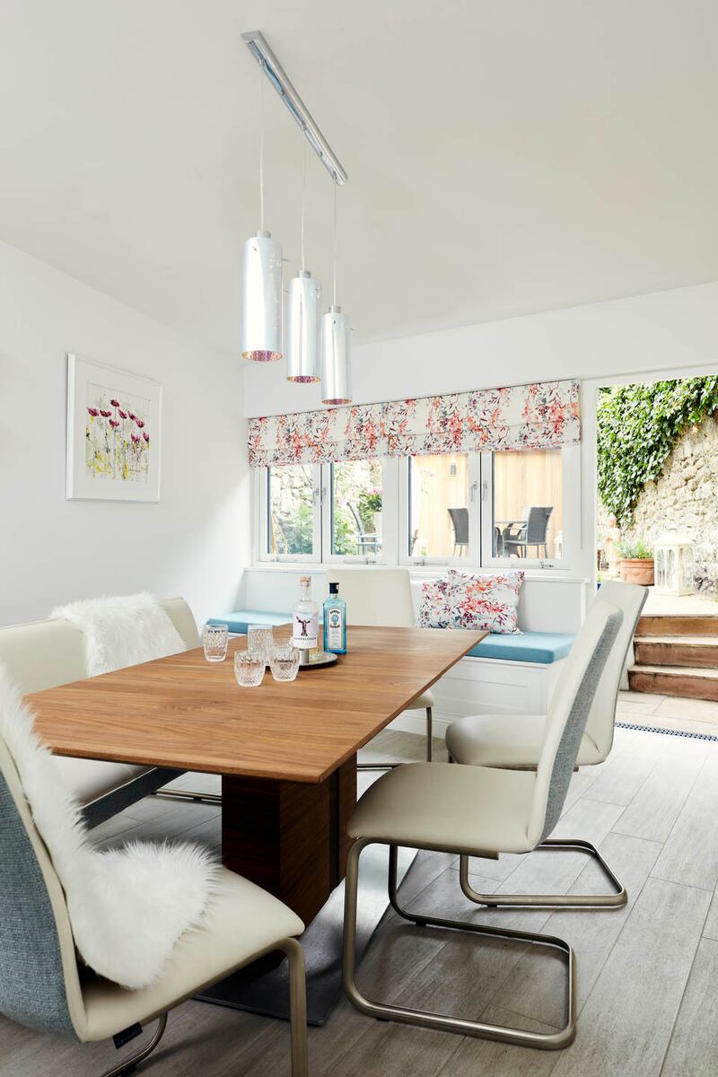 A rooflight, band of windows and white paint brighten the extension. Photograph: Philip Lauterbach