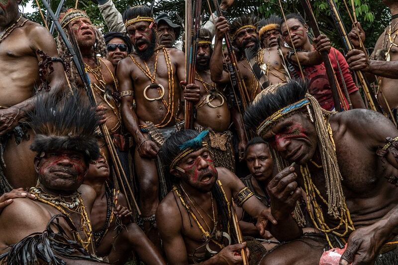 Tribesmen in traditional dress prepare for a performance in Goroka.