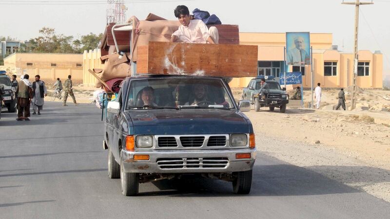 Afghan residents leave their home  in Kunduz. Photograph: Stringer/Reuters