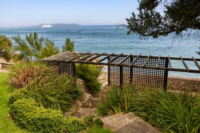 Gardens gently roll down to the sea