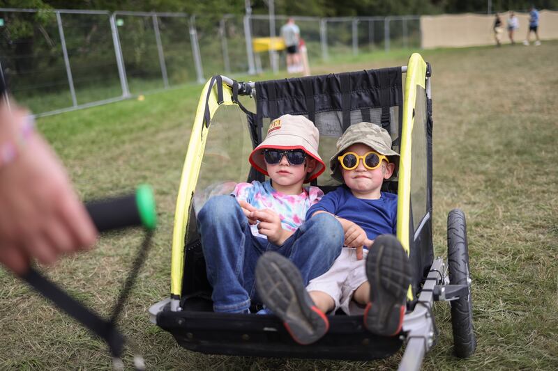 Seamus Ryan (4) and Rory Ryan (2) from Co Tipperary hitch a ride on the first day of the festival. Photograph: Dan Dennison
