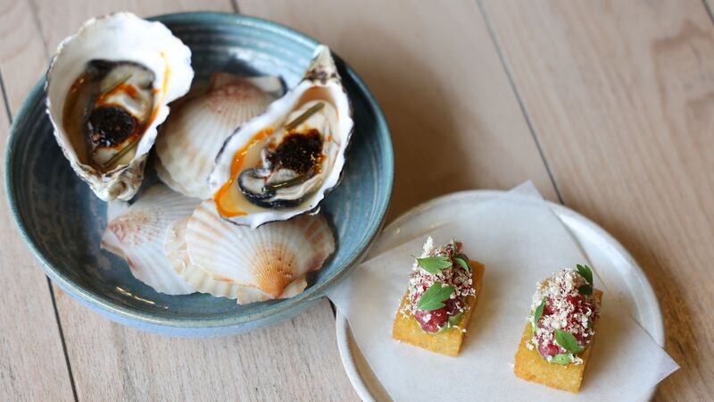 Poached oyster, morita chilli, fennel pollen, and confit potato, lovage, beef tartar. Photograph: Nick Bradshaw
