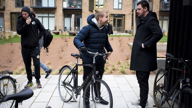Team Origen’s Jonas Andersen, centre, chats to head coach André Guilhoto as the team departs by bike for a workout. Photograph: Pete Kiehart/ The New York Times