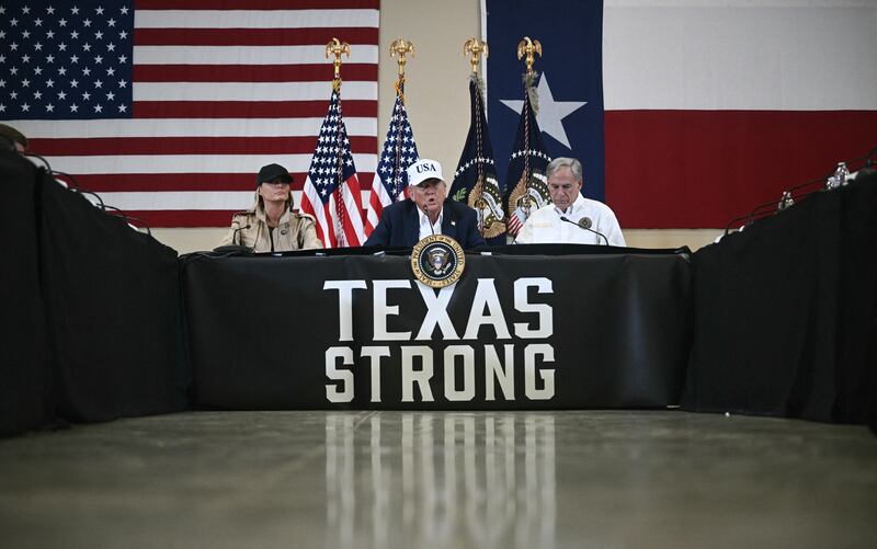 US president Donald Trump and first lady Melania Trump sit with Texas governor Greg Abbott as they attend a roundtable meeting with local officials and first responders at the Happy State Bank Expo Hall in Kerrville, Texas, on Friday. Photograph: Brendan Smialowski/AFP