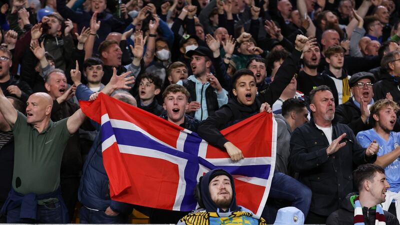 Manchester City fans hold up a Norway flag to celebrate the signing of Erland Haaland, during their win over Wolves on Wednesday night. Photograph: EPA