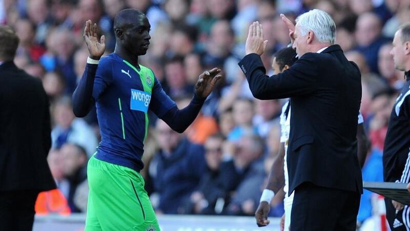 Newcastle United’s  Papiss Cisse (centre) is congratulated by under-fire manager Alan Pardew (right) after his brace against  Swansea City  at Liberty Stadium.  Photograph:  Stu Forster/Getty Images