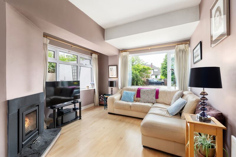 The front livingroom is dual-aspect and warmed by a stove