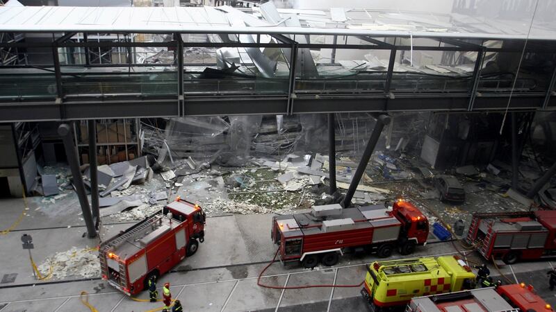 Firemen work inside the car park of Terminal 4 of Barajas Airport in Madrid after a bomb planted by armed Basque separatist group Eta exploded, killing two people. Photograph: Javier Soriano/AFP/Getty Images