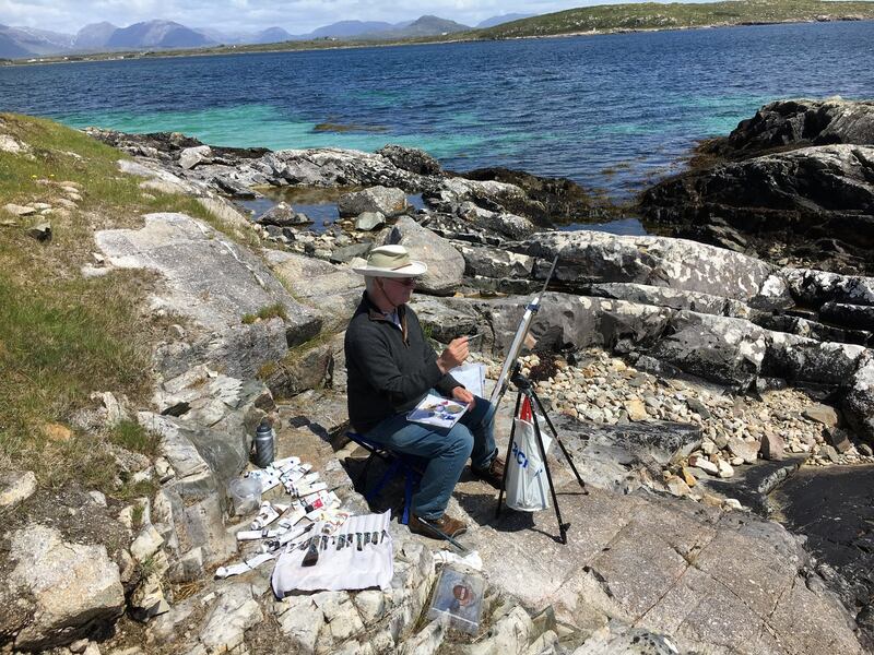 Michael Doherty working in windy conditions by the shore, easel weighted down with a bag of stones, 2018. Photograph: Nancy Keefe Rhodes
