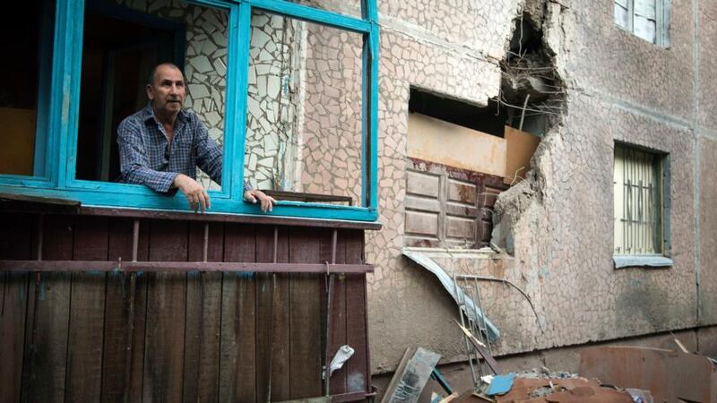 Valery (63) looks out of a window of his apartment, which was damaged by shelling, in Slaviansk in eastern Ukraine Photograph: Shamil Zhumatov/Reuters